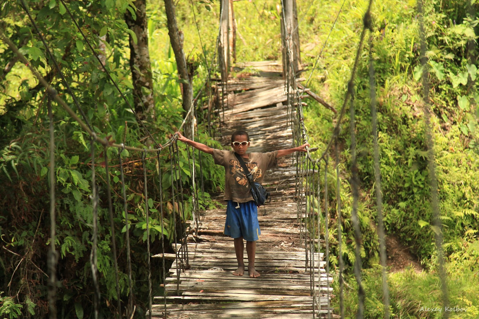 Bare foot of western tourist after trekking with hiking boots in West Papua  highlands and bare foot of his papuan guide who walked the same paths  barefoot, Baliem Valley, Wamena, Indonesia Photos