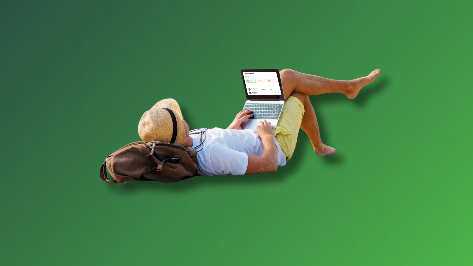 Man lying on a beach working away