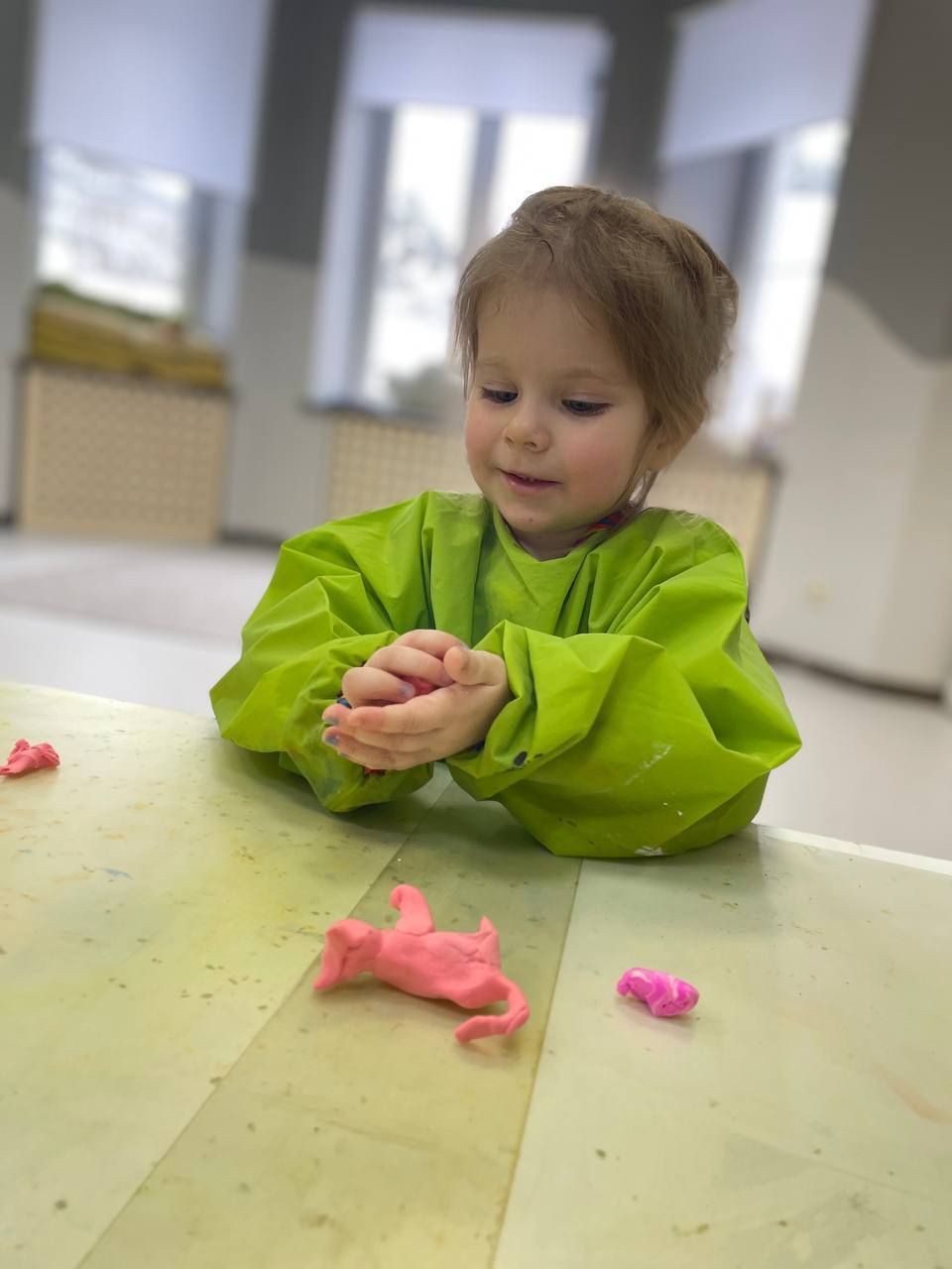 Ребёнок лепит котика из пластилина на занятии в детском саду Magic Beans