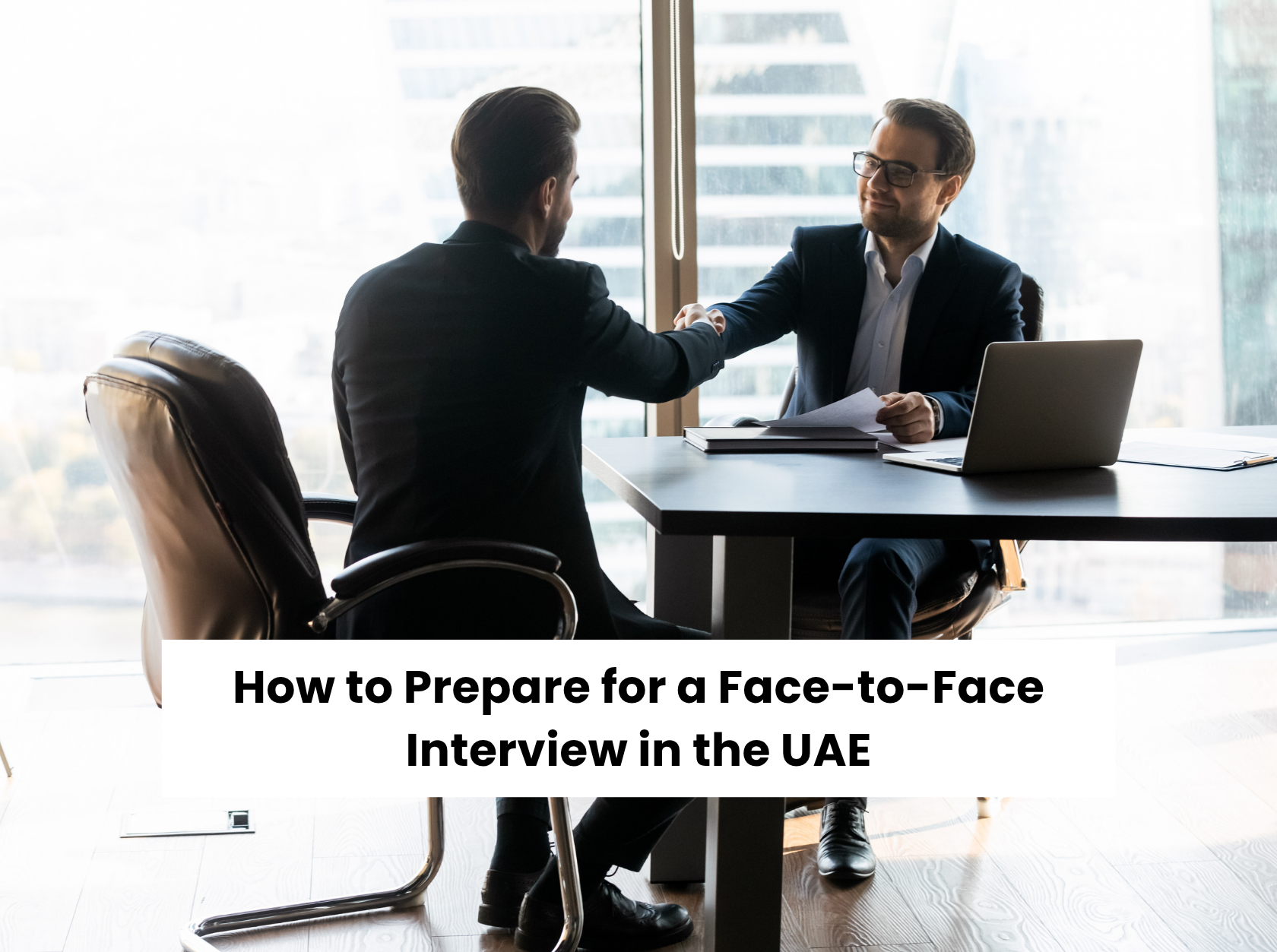 Job interview success in the UAE – candidate and interviewer shaking hands confidently after a face-to-face interview