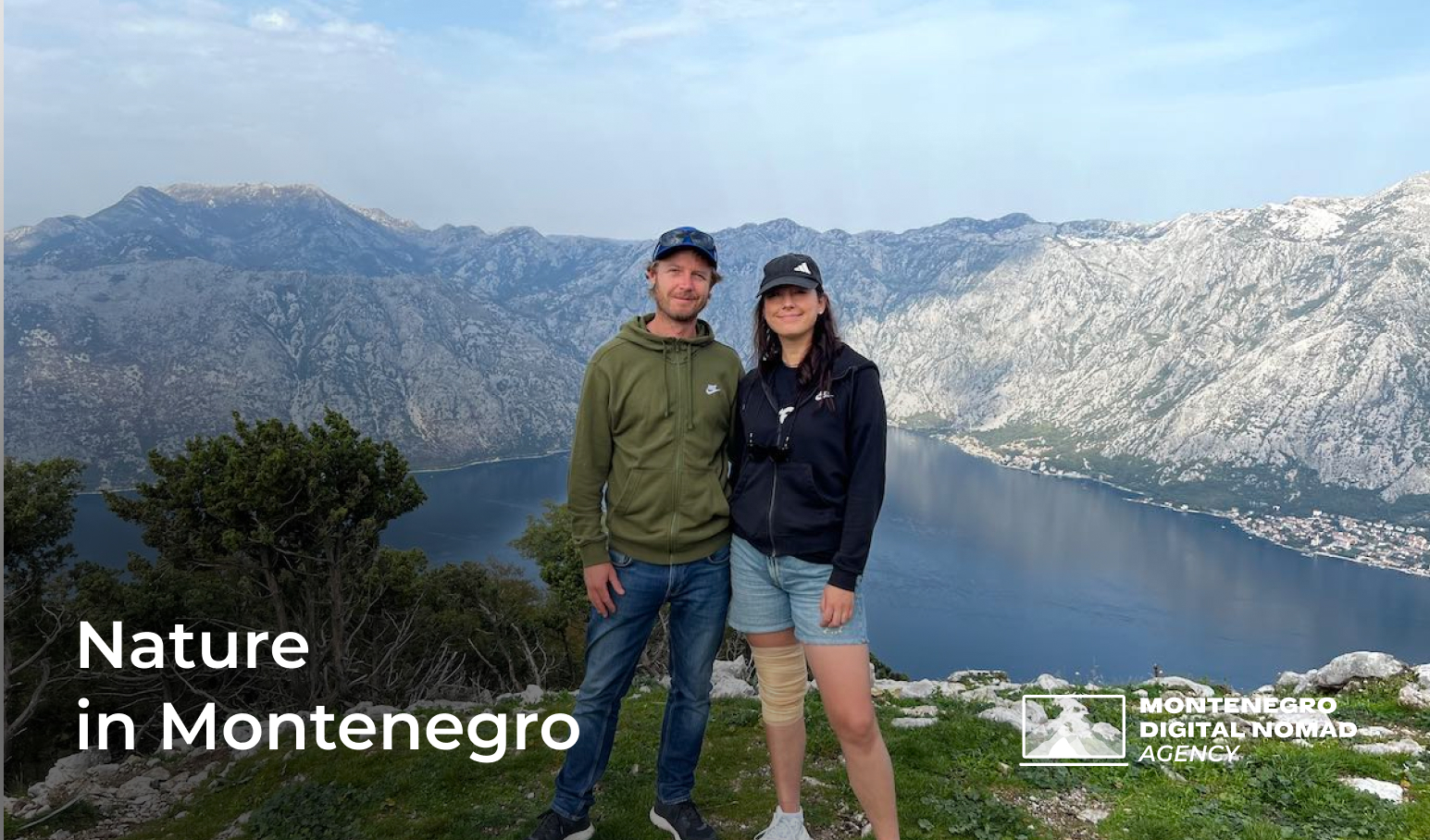 Photo of a young couple standing in front of a mountain view in Montenegro