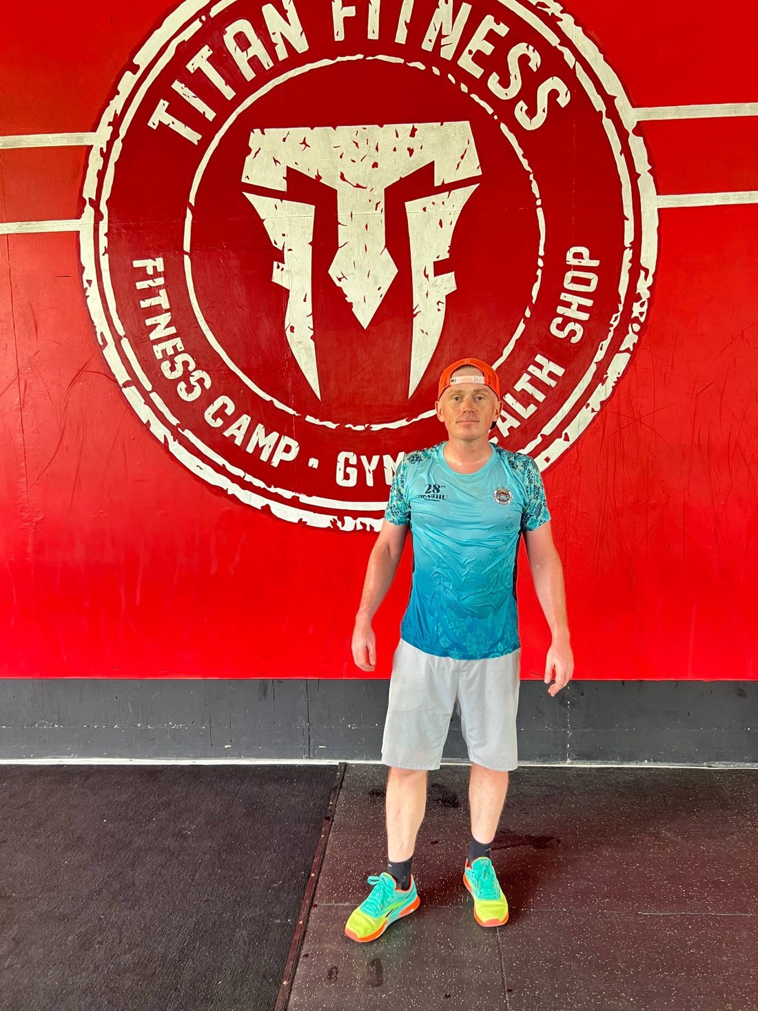 Павел Ростовцев у вывески Titan Fitness Camp на спортивной улице Пхукета