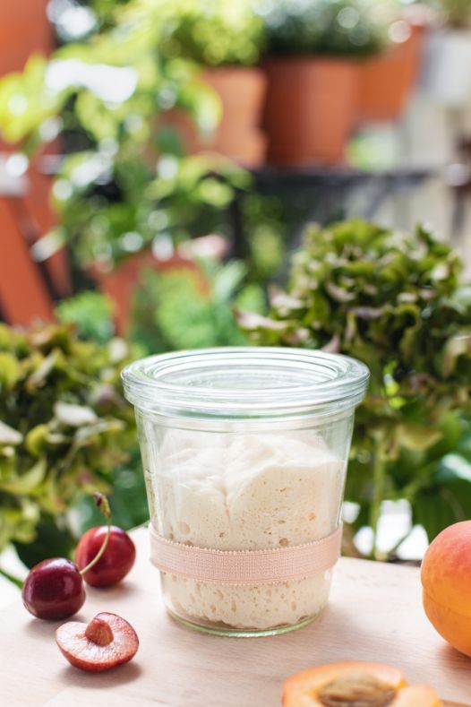 Traditional Levito Madre sourdough starter in a glass jar on a wooden table