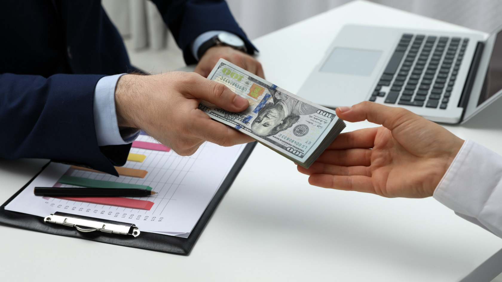 Two business professionals agreeing on a non-dilutive funding deal and exchanging money.