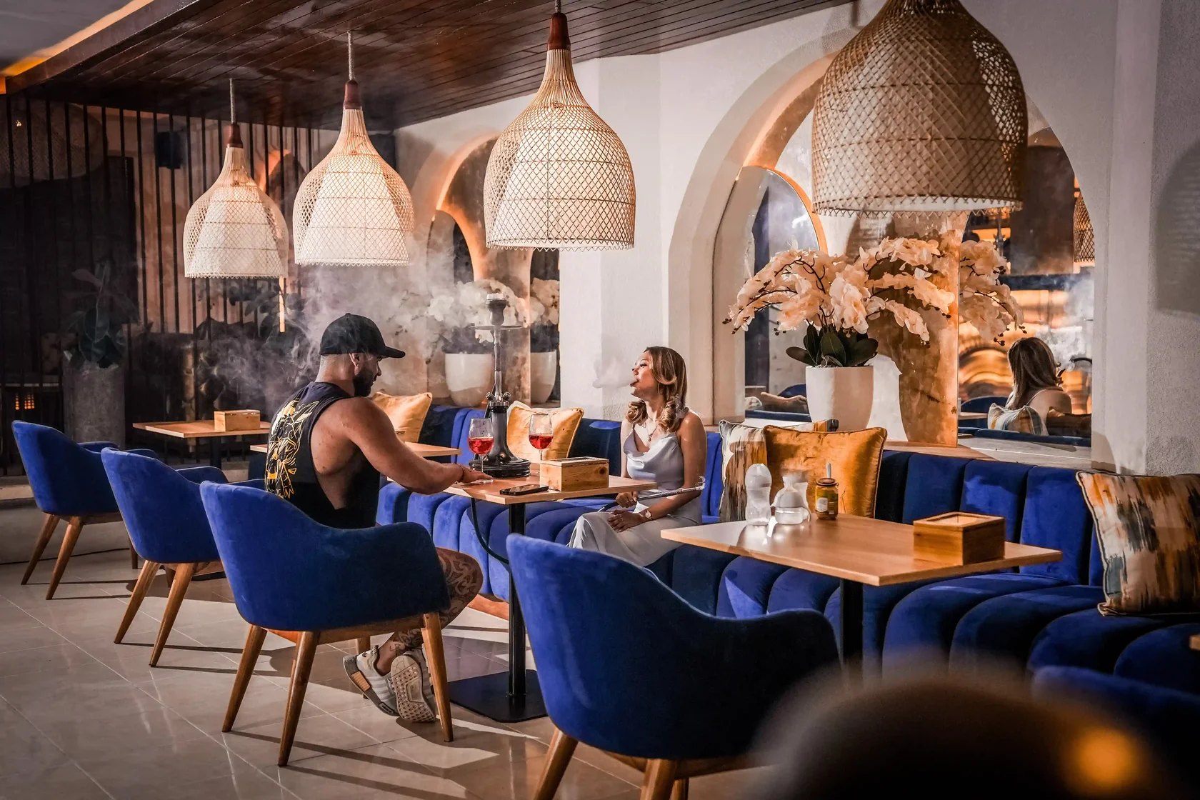 A couple enjoying a premium shisha session at Eden Hookah Club, an elegant and relaxing choice when deciding what to do in Ubud at night.